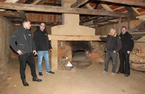 Der alte Backofen soll wieder brennen (von links): Die Handwerker Jan Schleicher und Tino Niess von Brawa Nord, Eigentümer Achim Peters und Zimmermeister Marco Matthies freuen sich über die gelungene Sanierung des alten Backhauses. Foto: Landkreis Harburg